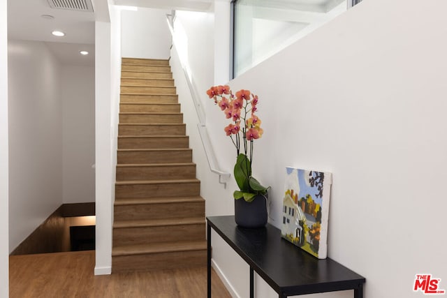 staircase featuring hardwood / wood-style floors