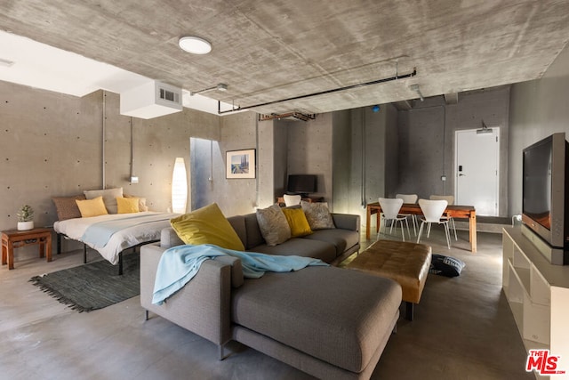 bedroom featuring concrete floors