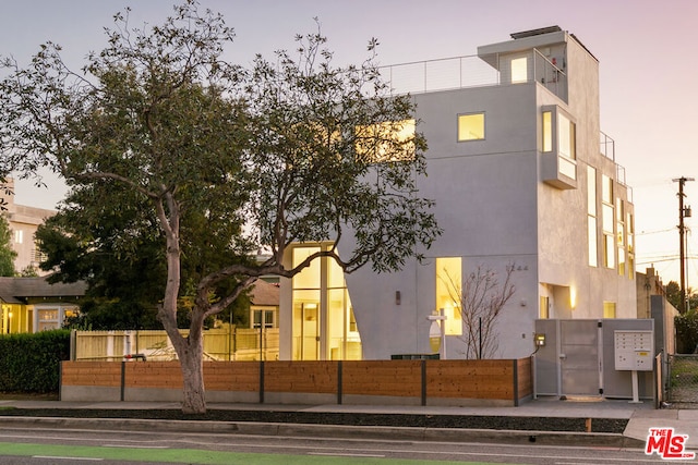 view of outdoor building at dusk