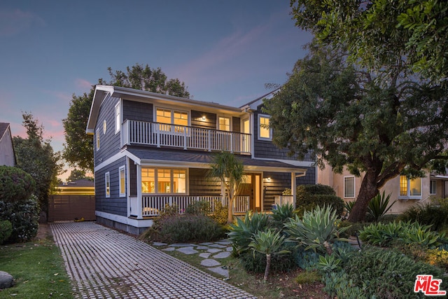 view of front of house with a porch and a balcony