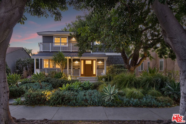 view of front of property with a balcony and a porch