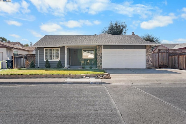 ranch-style home featuring a garage and a front yard