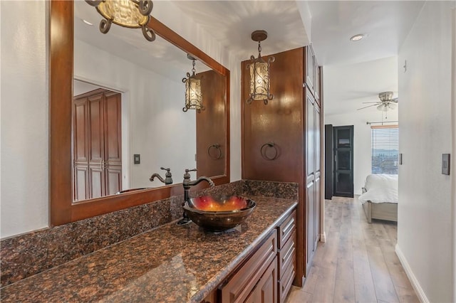 bathroom with ceiling fan, vanity, and hardwood / wood-style floors