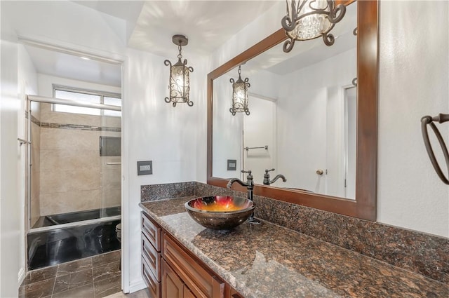 full bathroom with vanity, shower / bath combination with glass door, and toilet