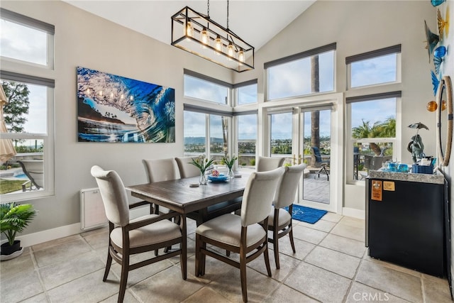 dining space with a notable chandelier and high vaulted ceiling