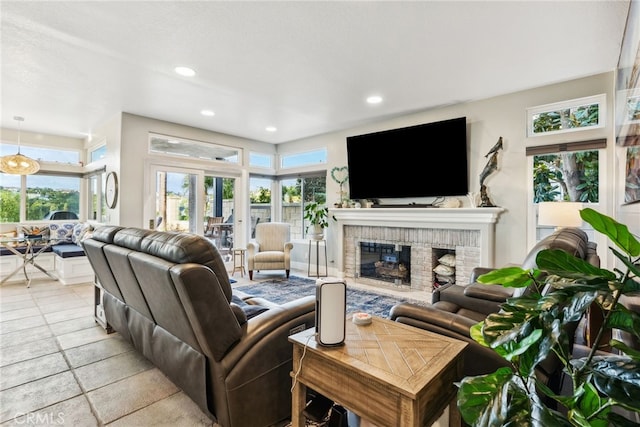 living room with a fireplace and a wealth of natural light