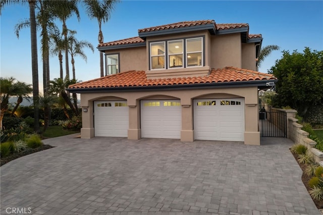 mediterranean / spanish home featuring a garage