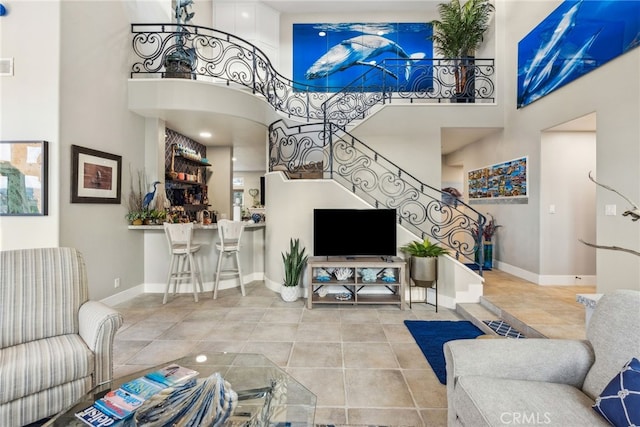 tiled living room with a high ceiling and bar area