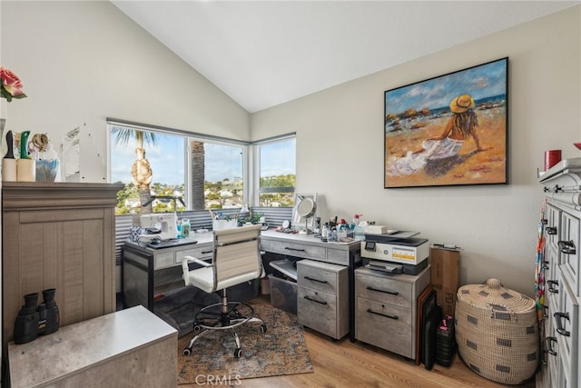 office area with vaulted ceiling and light hardwood / wood-style flooring