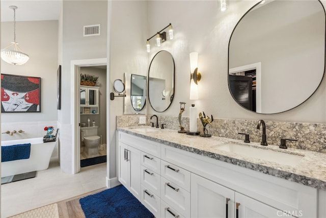 bathroom with a bathing tub, wood-type flooring, tile walls, vanity, and toilet