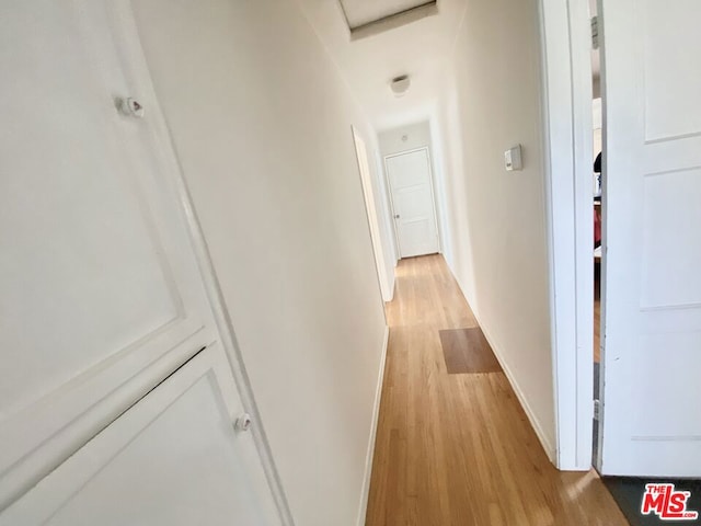 corridor featuring light hardwood / wood-style floors