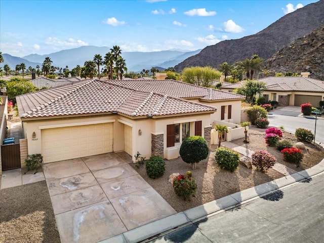 mediterranean / spanish-style house featuring a garage and a mountain view