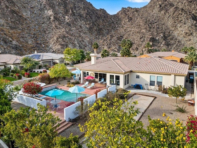 exterior space with a mountain view and a patio