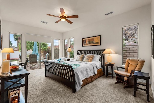 carpeted bedroom featuring access to exterior and ceiling fan