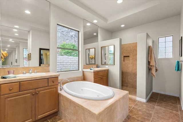 bathroom with vanity, plus walk in shower, and tile patterned flooring