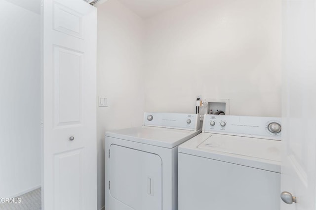 clothes washing area featuring washer and dryer