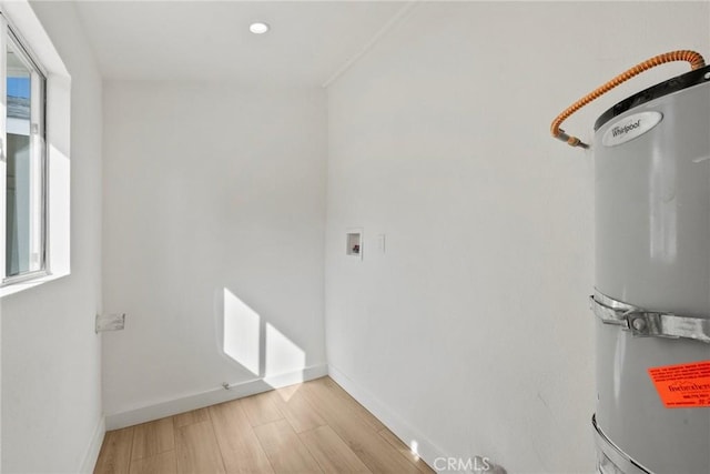 utility room featuring water heater