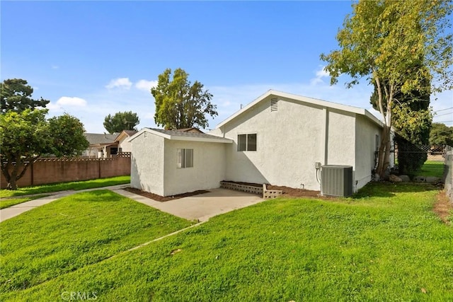 rear view of house featuring a patio, a yard, and cooling unit