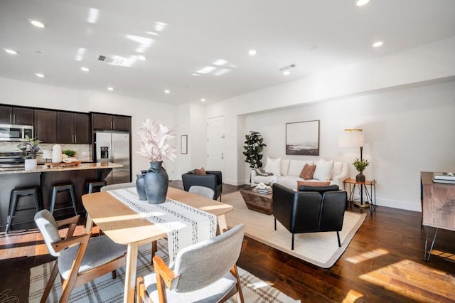 dining room with dark hardwood / wood-style floors