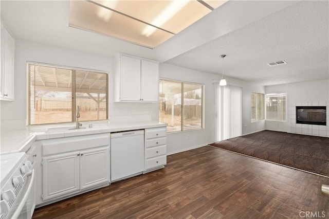 kitchen with white cabinets, white dishwasher, hanging light fixtures, and stove