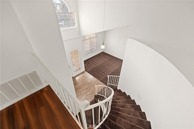 stairway featuring wood-type flooring