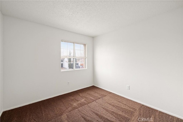 carpeted spare room with a textured ceiling