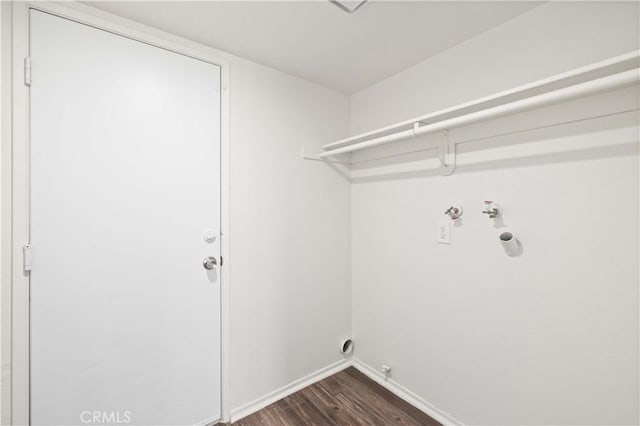 washroom featuring dark wood-type flooring, hookup for a gas dryer, hookup for a washing machine, and electric dryer hookup