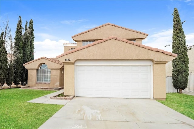 mediterranean / spanish-style home with a tile roof, concrete driveway, a front yard, stucco siding, and an attached garage