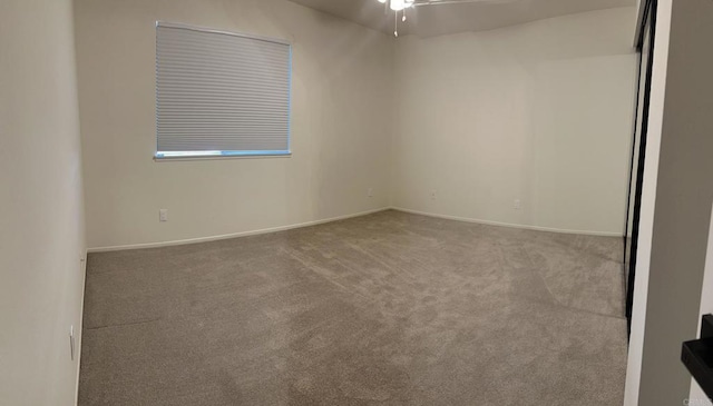 carpeted empty room featuring ceiling fan