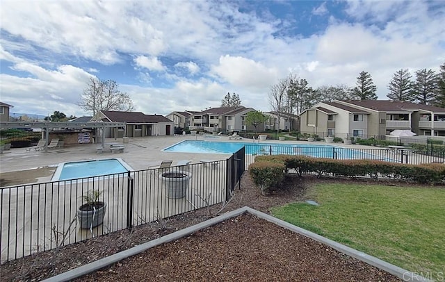 view of pool featuring a lawn and a patio area