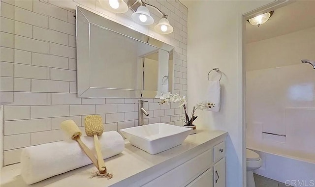 bathroom with tasteful backsplash, vanity, and toilet