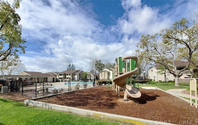 view of jungle gym featuring a community pool