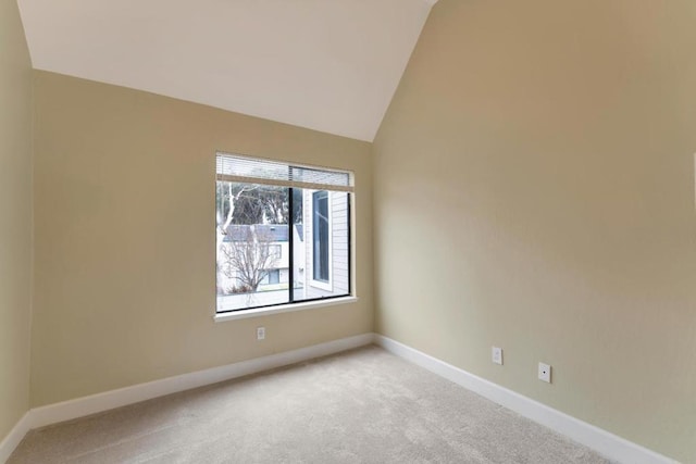 unfurnished room with high vaulted ceiling and light carpet