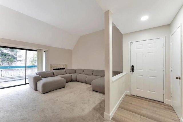 living room with lofted ceiling and light wood-type flooring