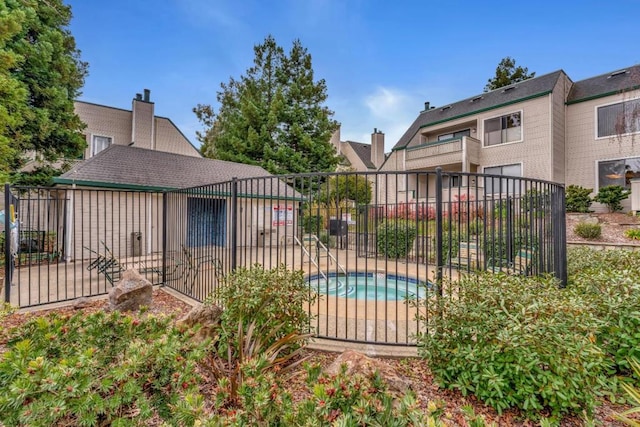 view of pool with an in ground hot tub