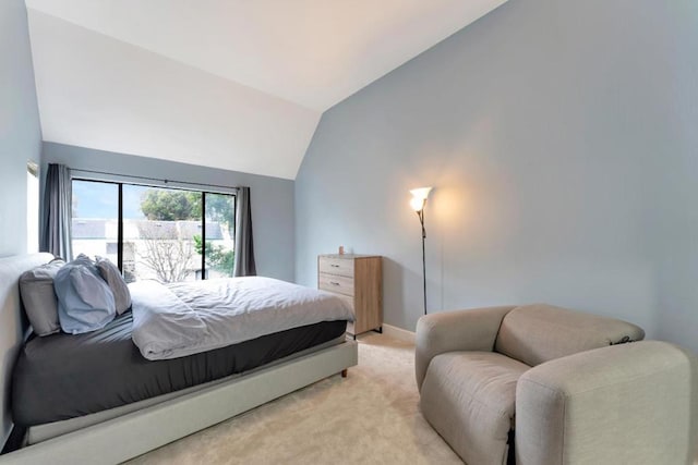 bedroom featuring vaulted ceiling and light carpet