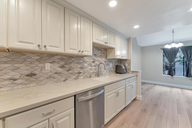 kitchen with sink, white cabinets, and dishwasher