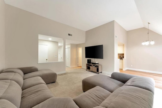 living room with high vaulted ceiling and a notable chandelier