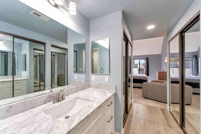 bathroom with hardwood / wood-style flooring and vanity