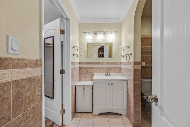 bathroom featuring tile patterned flooring, ornamental molding, tile walls, and vanity