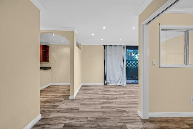 hallway featuring ornamental molding and light hardwood / wood-style flooring