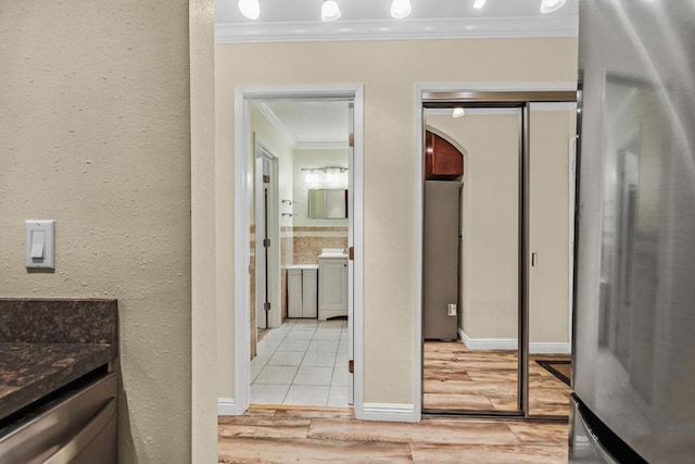 bathroom with hardwood / wood-style flooring, ornamental molding, and vanity