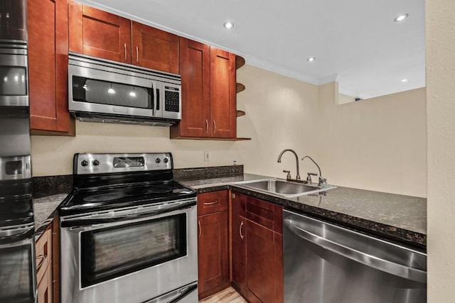 kitchen with sink, dark stone countertops, kitchen peninsula, stainless steel appliances, and crown molding