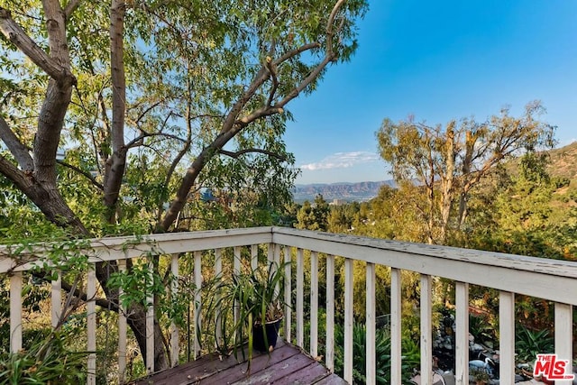 wooden deck with a mountain view