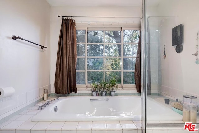 bathroom with tiled tub