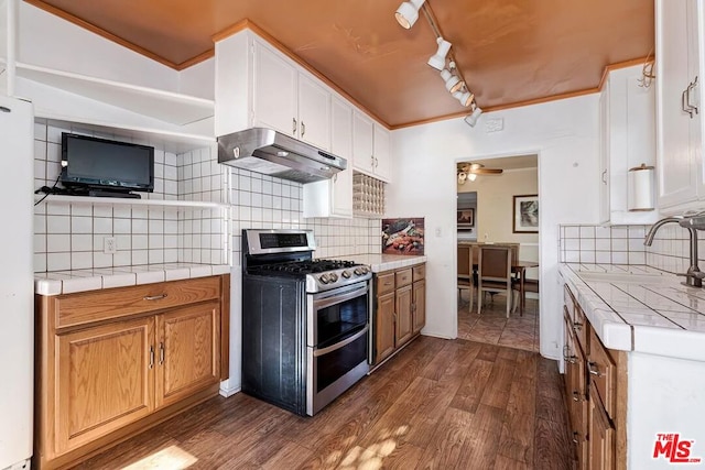 kitchen featuring dark hardwood / wood-style floors, white cabinets, range with two ovens, tile counters, and ceiling fan