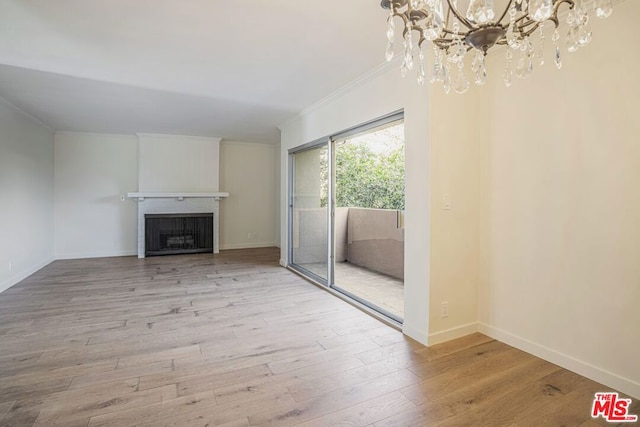 unfurnished living room featuring crown molding and light hardwood / wood-style flooring