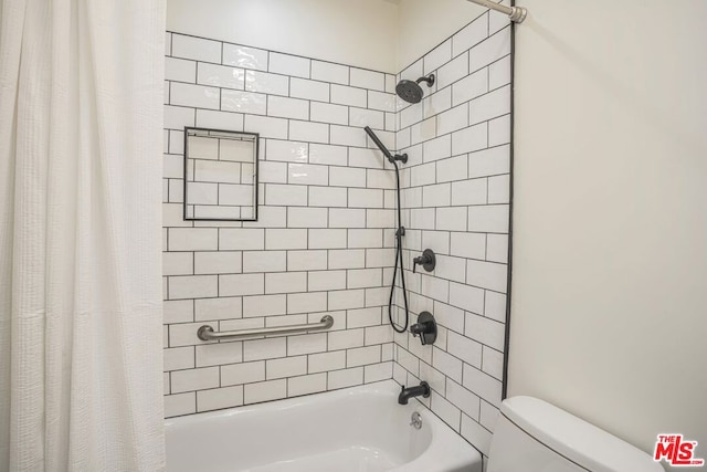 bathroom featuring shower / bathtub combination with curtain and toilet