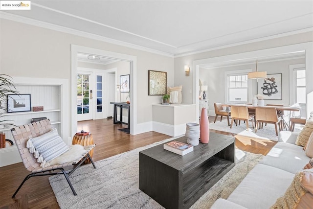 living room with hardwood / wood-style flooring and ornamental molding