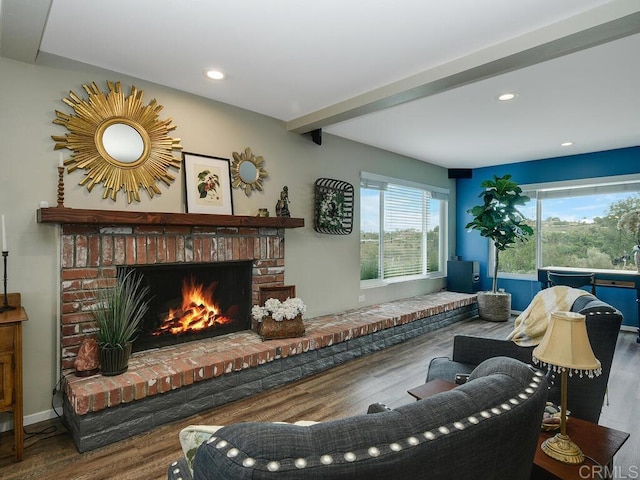 living room with hardwood / wood-style flooring, a fireplace, and beam ceiling